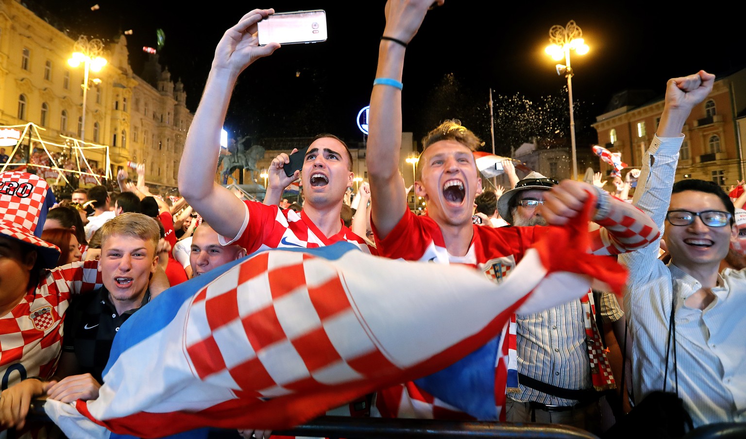 epa06814542 Croatian national soccer team fans celebrate winning he FIFA World Cup 2018 group D preliminary round soccer match between Croatia and Nigeria in downtown Zagreb, Croatia, 16 June 2018. EP ...