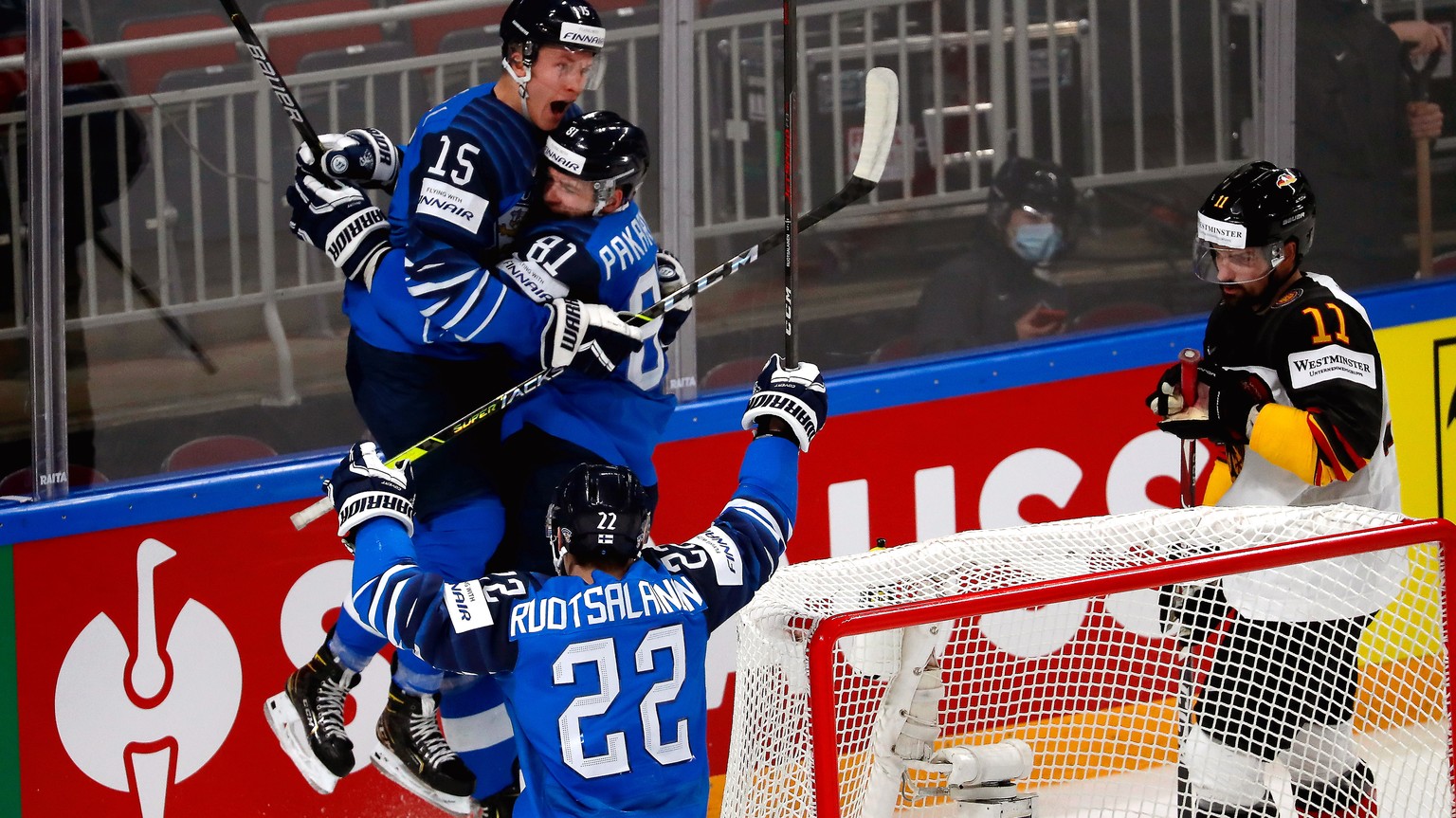 epa09249768 Iiro Pakarinen (back C) of Finland celebrates with teammates Arttu Ruotsalainen (front) and Anton Lundell (L) after scoring the 1-0 lead during the IIHF Ice Hockey World Championship 2021  ...