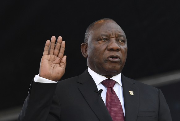 epa07598899 Cyril Ramaphosa takes the oath of office at his inauguration as South African President at Loftus Versfeld stadium in Pretoria, South Africa, 25 May 2019. South African lawmakers elected C ...