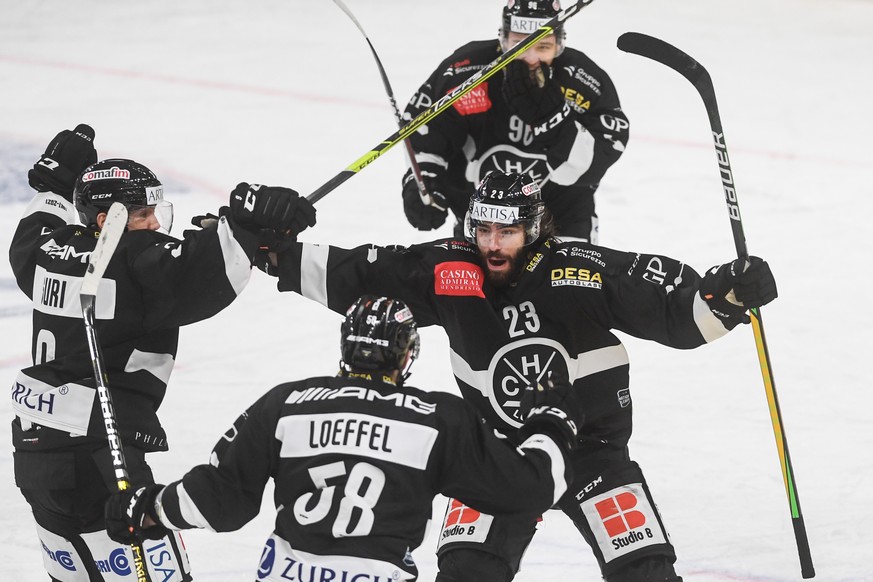 Lugano?s player Giovanni Morini, no 23 center, celebrates the 2-2 goal with his teammates, from left, during the preliminary round game of National League (NLA) Swiss Championship 2020/21 HC Lugano ag ...