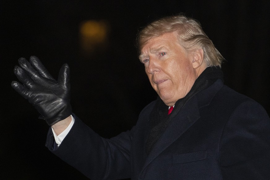 President Donald Trump waves upon arrival back to the White House from a campaign rally in Battle Creek, Mich., early Thursday, Dec. 19, 2019, in Washington. Trump was impeached by the U.S. House of R ...