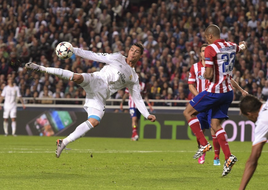 FILE - In this May 24, 2014 file photo Real&#039;s Cristiano Ronaldo kicks the ball near to Atletico&#039;s Miranda during the Champions League final soccer match between Atletico Madrid and Real Madr ...