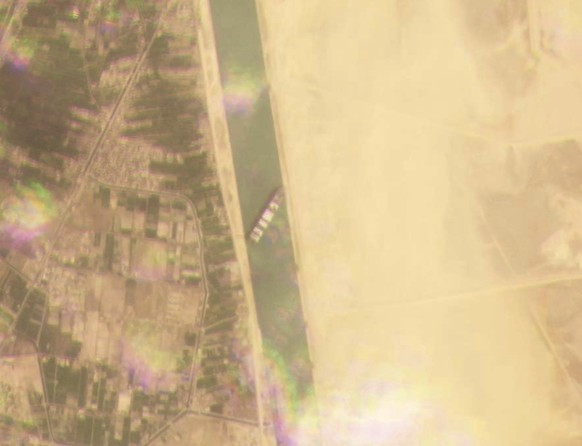 This satellite image from Planet Labs Inc. shows the cargo ship MV Ever Given stuck in the Suez Canal near Suez, Egypt, Tuesday, March 23, 2021. A cargo container ship that&#039;s among the largest in ...