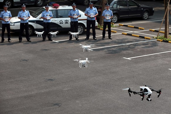 epa04850120 An archive picture made available on 17 July 2015 of of policemen practicing controlling drones after the establishment ceremony of the first police drone squad in Nanjing, Jiangsu provinc ...