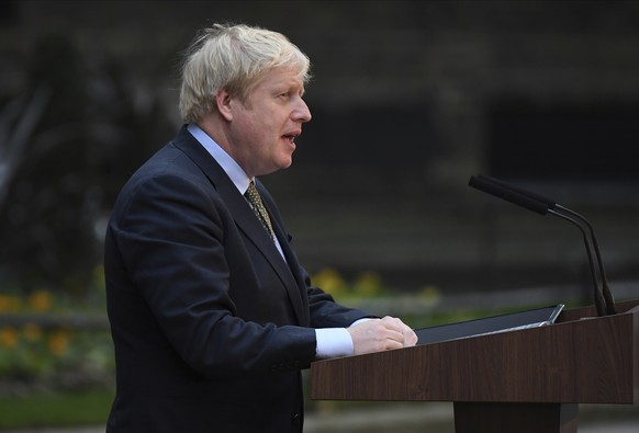 Britain&#039;s Prime Minister Boris Johnson waves on the steps after speaking outside 10 Downing Street in London on Friday, Dec. 13, 2019. Boris Johnson&#039;s gamble on early elections paid off as v ...
