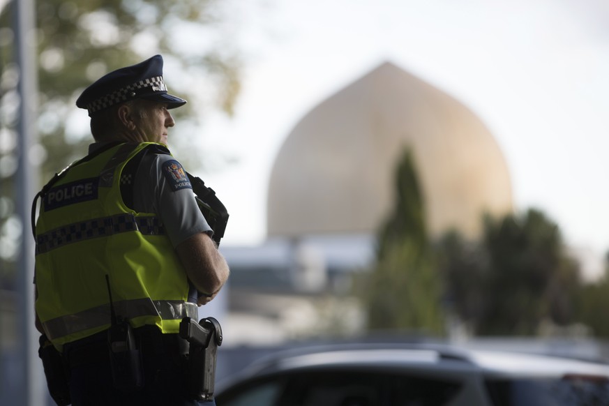 A police official stands guard in front of the Al Noor mosque in Christchurch, New Zealand, Tuesday, March 19, 2019. Christchurch was beginning to return to a semblance of normalcy Tuesday. Streets ne ...