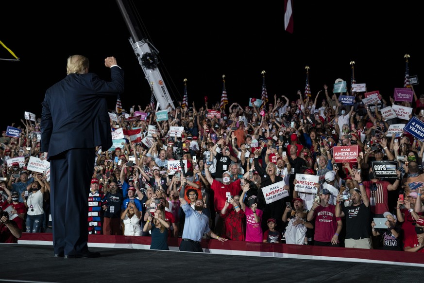 President Donald Trump pumps his fist as he walks off after speaking at a campaign rally at Orlando Sanford International Airport, Monday, Oct. 12, 2020, in Sanford, Fla. (AP Photo/Evan Vucci)
Donald  ...