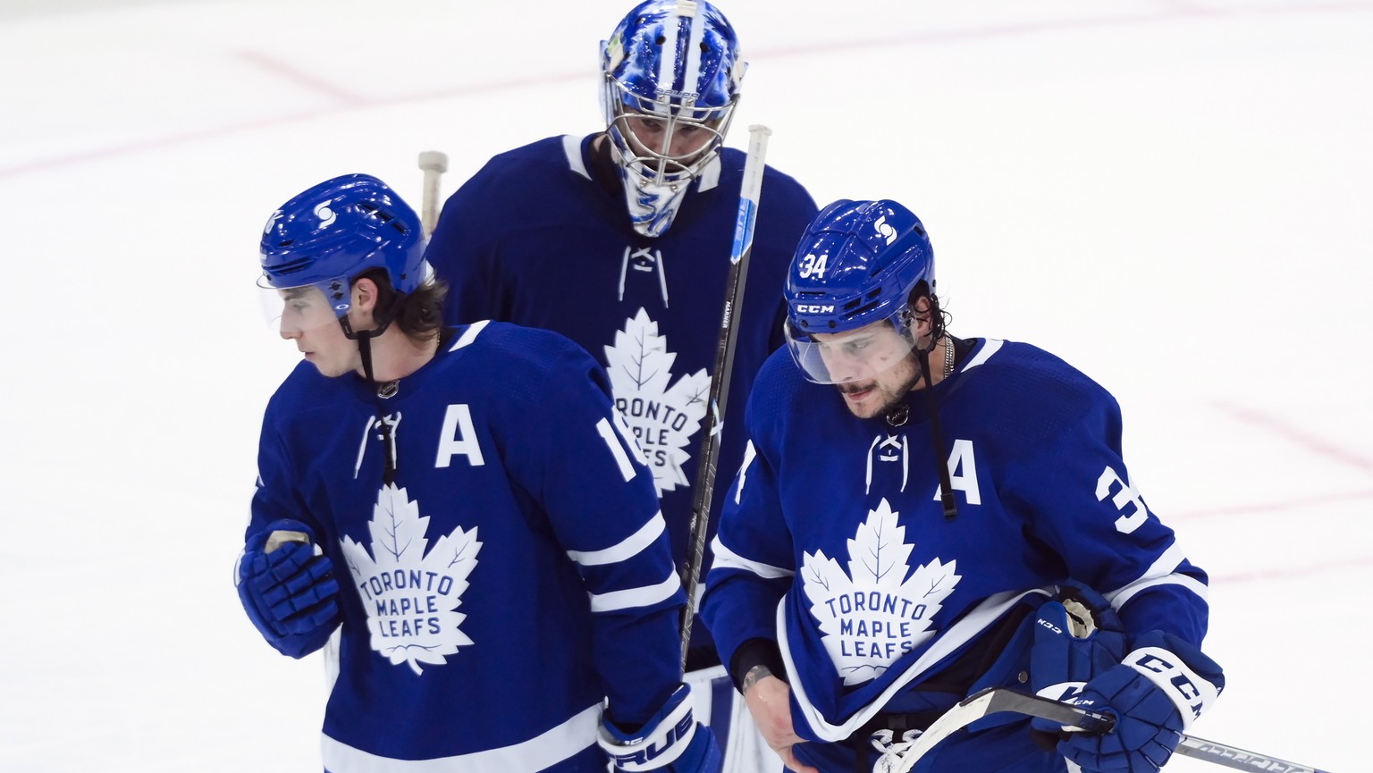 Toronto Maple Leafs forward Auston Matthews (34) and teammates Mitchell Marner (16) and Jack Campbell (36) skate off at the end of third-period NHL Stanley Cup hockey game action against the Montreal  ...