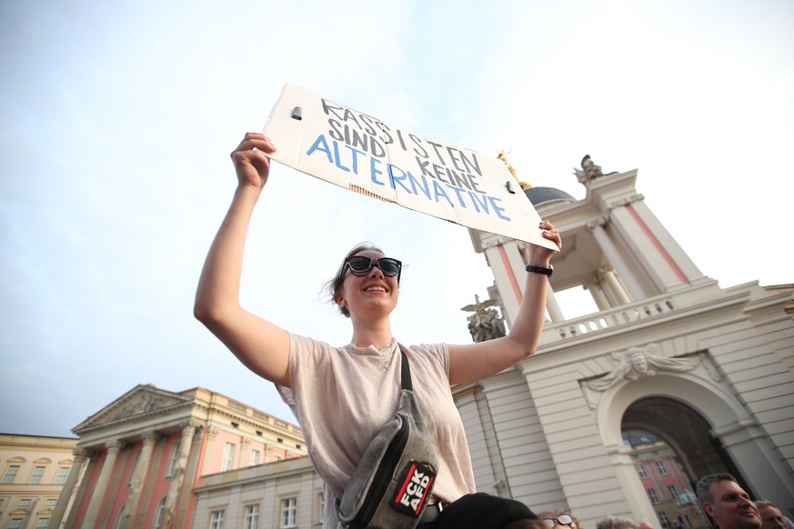 epa07810936 Anti AfD (Alternative fuer Deutschland) protester holds a placard reading &#039;Racism is not an Alternative&#039; during the Brandenburg state elections in Potsdam, Germany, 01 September  ...