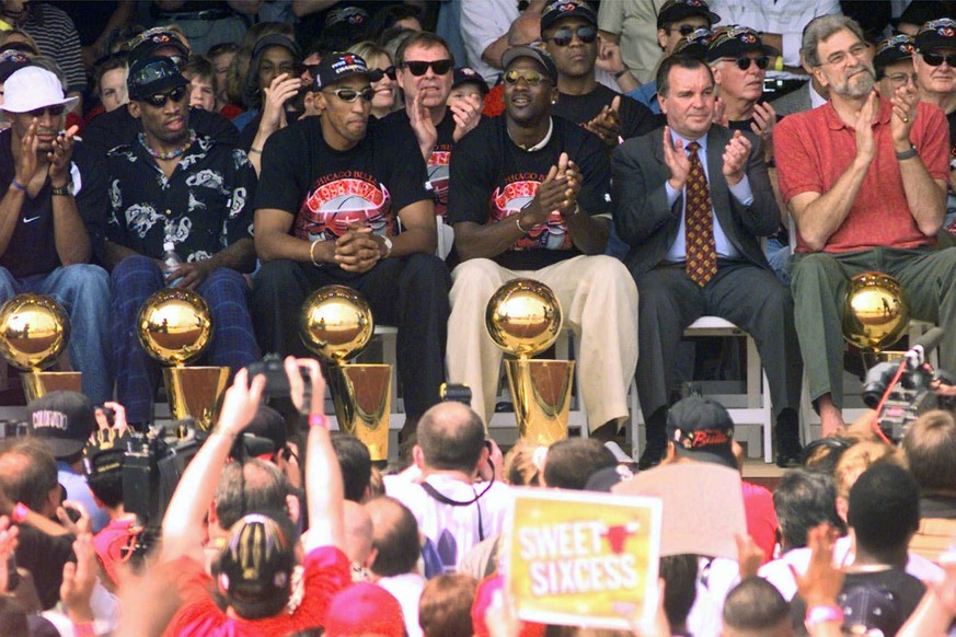 FILE - In this June 16, 1998, file photo, NBA Champions, from left: Ron Harper, Dennis Rodman, Scottie Pippen, Michael Jordan and coach Phil Jackson are joined on stage by Chicago Mayor Richard Daley, ...