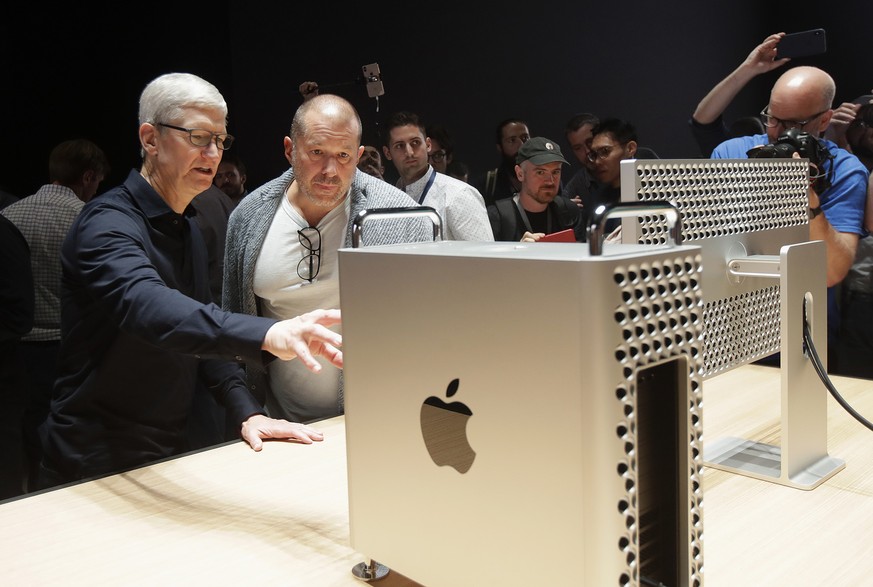 Apple CEO Tim Cook, left, and chief design officer Jonathan Ive look at a Mac Pro in the display room at the Apple Worldwide Developers Conference in San Jose, Calif., Monday, June 3, 2019. (AP Photo/ ...