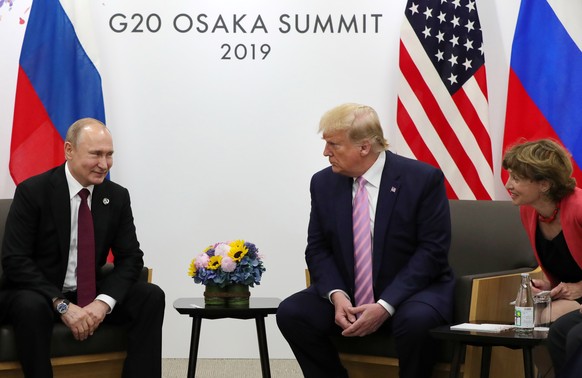 epa07679270 Russian President Vladimir Putin (L) and US President Donald J. Trump (R) meet on the sidelines of the G20 summit in Osaka, Japan, 28 June 2019. It is the first time that Japan hosts a G20 ...
