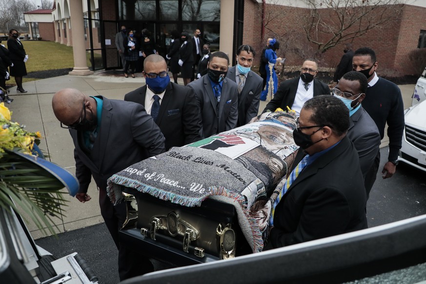 Pallbearers carry the casket of Andre Hill to a hearse following funeral services on Tuesday, Jan. 5, 2021 at First Church of God in Columbus, Ohio. A white Ohio police officer was indicted Wednesday, ...