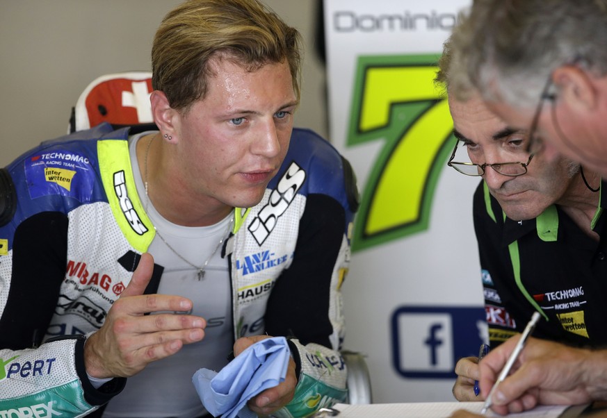 Swiss Moto2 rider Dominique Aegerter talks with a crew member during the third practice Indianapolis Grand Prix motorcycle race at Indianapolis Motor Speedway in Indianapolis, Saturday, Aug. 8, 2015.  ...