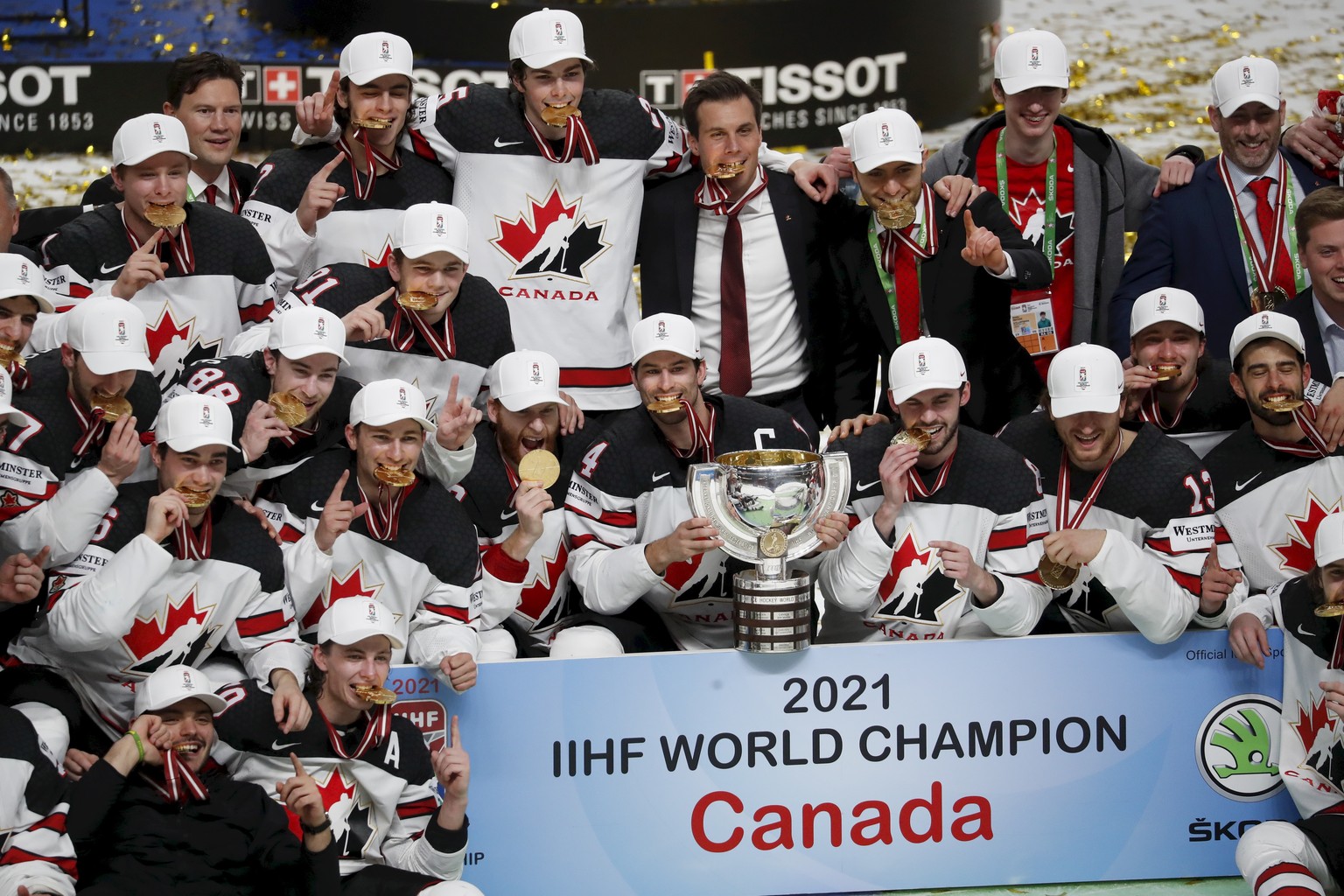 epa09252106 Players of Canada celebrate with the trophy after winning the IIHF Ice Hockey World Championship 2021 final match between Finland and Canada at the Arena Riga, Latvia, 06 June 2021. EPA/TO ...