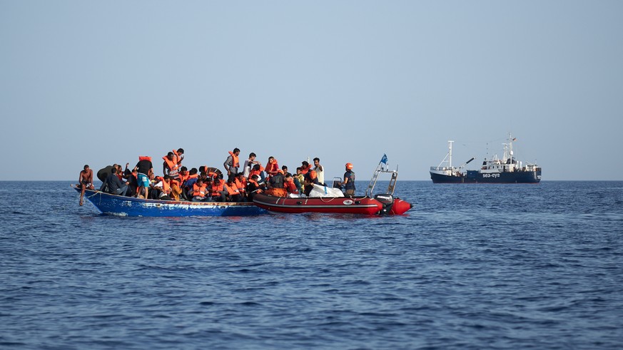 epa07704799 A handout photo made available by German civil sea rescue organisation sea-eye shows a boat carrying migrants (L) and a rescue boat of sea-eye, in the Mediterranean Sea, 08 July 2019 (issu ...