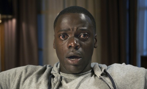 This image released by Universal Pictures shows Daniel Kaluuya in a scene from, &quot;Get Out.&quot; Jordan Peele’s thriller sensation “Get Out” crossed $100 million over the weekend, reaching that mi ...