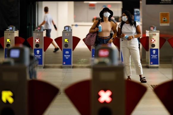 epa08916188 Commuters are seen wearing masks at a train station in Sydney, New South Wales, Australia, 03 January 2021. Mandatory mask restrictions are in place for many venues across greater Sydney a ...