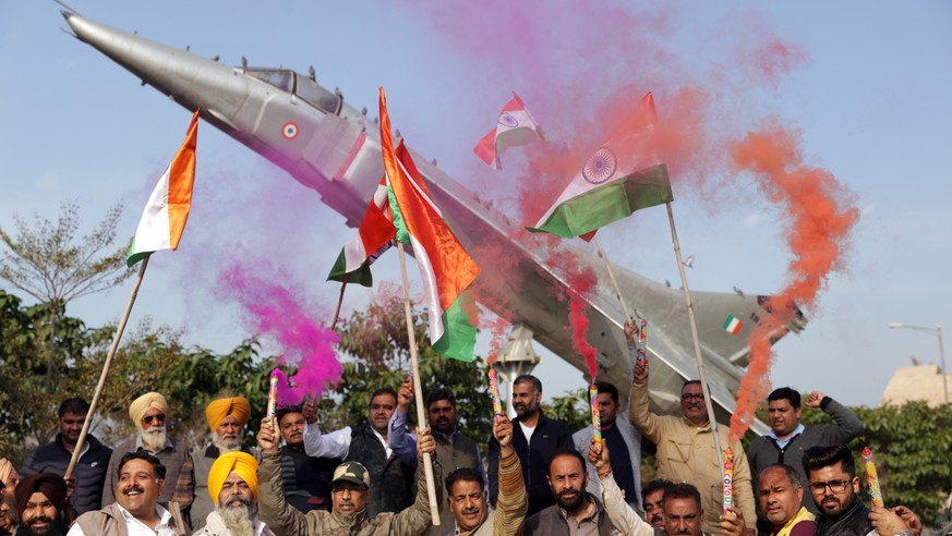 epa07398537 Bhartiya Janta Party (BJP) workers hold Indian flags as they celebrate the Indian Air Force&#039;s air strike across the Line of Control (LoC) near the international border with Pakistan,  ...
