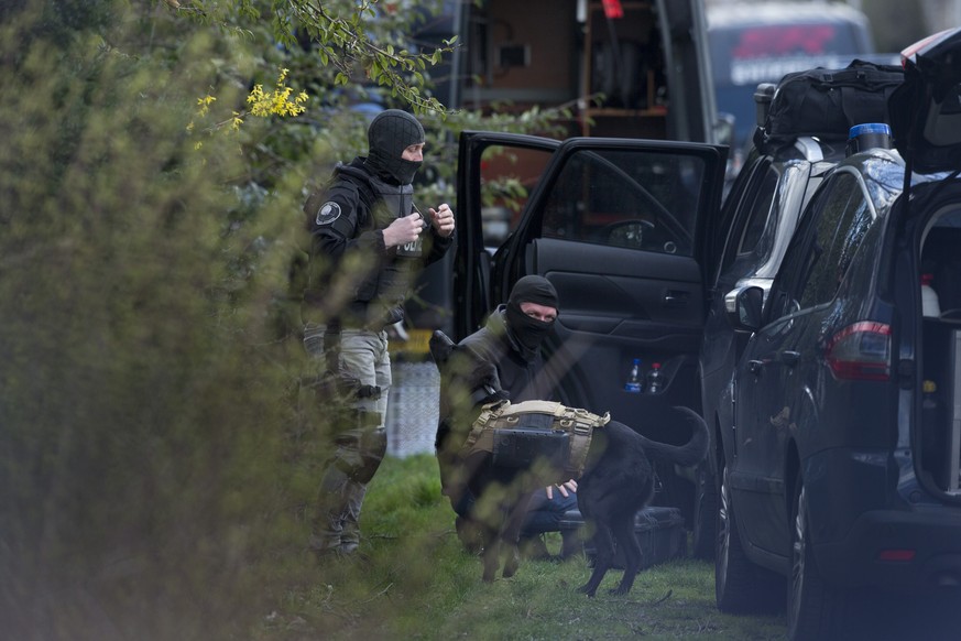 Dutch counter terrorism police prepare to enter a house with a sniffer dog equipped with a camera after a shooting incident in Utrecht, Netherlands, Monday, March 18, 2019. A gunman killed three peopl ...