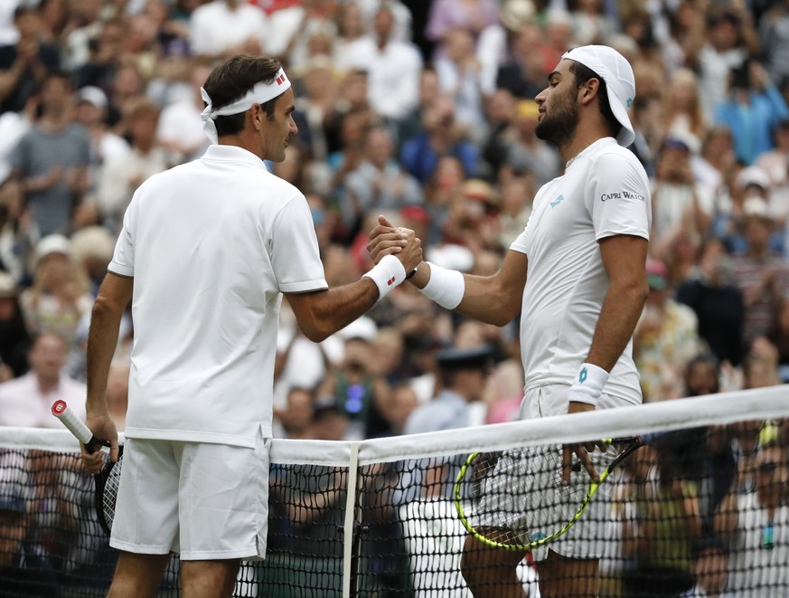 Switzerland&#039;s Roger Federer shakes hands with Italy&#039;s Matteo Berrettini after defeating him in a men&#039;s singles match during day seven of the Wimbledon Tennis Championships in London, Mo ...