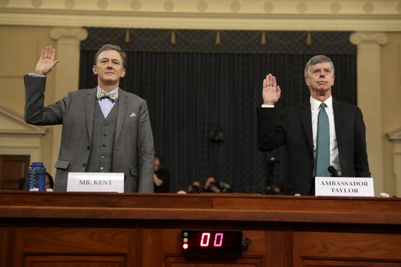 Career Foreign Service officer George Kent and top U.S. diplomat in Ukraine William Taylor, right, are sworn in to testify during the first public impeachment hearing of the House Intelligence Committ ...