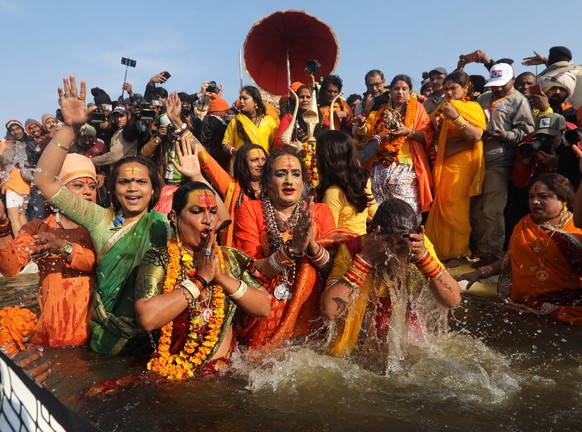 epa07285380 Head of Kinnar Akhara, a transgender congregation, Laxmi Narayan Tripathi (C) and members take a &#039;shahi snans&#039; or holy bath at the Sangam river, the confluence of three of the ho ...