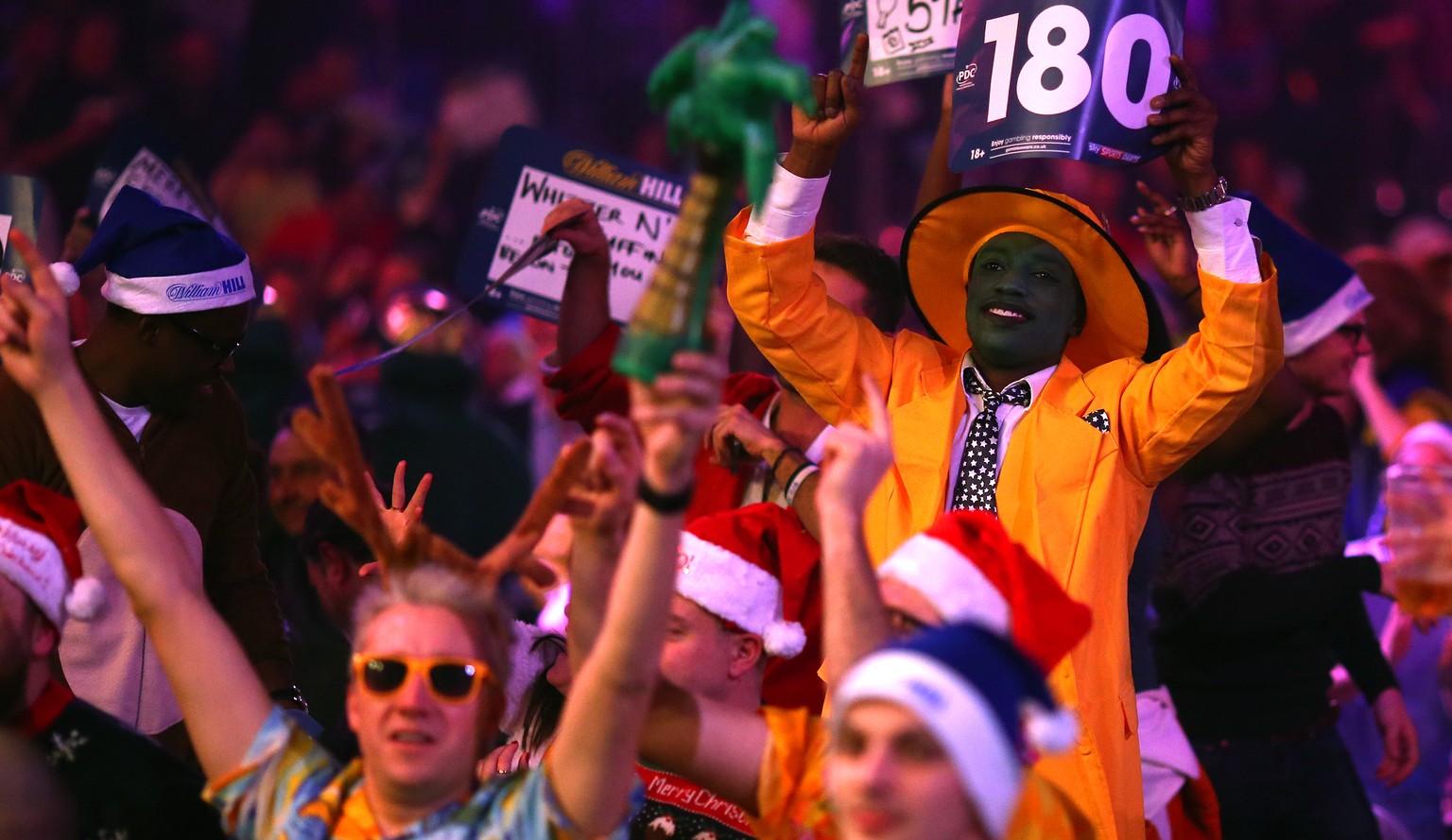 LONDON, ENGLAND - DECEMBER 22: Darts fans dress create the atmosphere during the William Hill PDC World Darts Championships on Day Five at Alexandra Palace on December 22, 2014 in London, England. (Ph ...