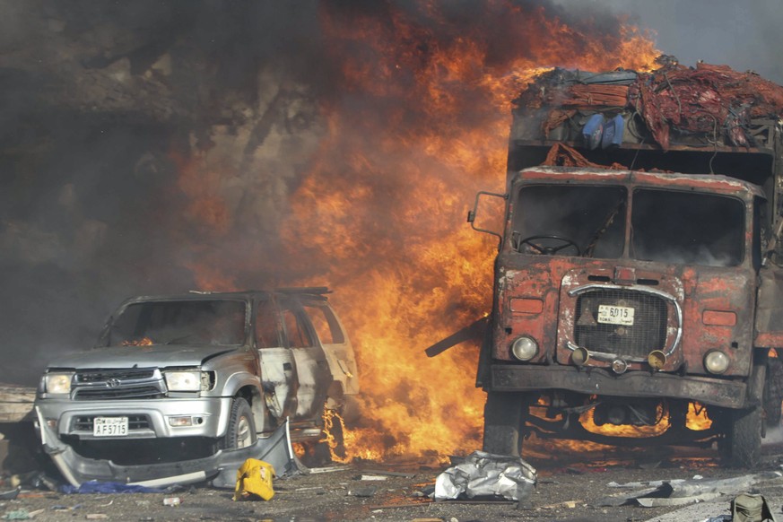 epa06265446 Vehicles burn at the scene of a massive explosion in front of Safari Hotel in the capital Mogadishu, Somalia, 14 October 2017. Reports state at least 20 peole have been killed when a truck ...