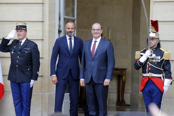 Outgoing French Prime Minister Edouard Philippe, left, and newly named Prime Minister Jean Castex pose before the hand over ceremony in Paris, Friday, July 3, 2020. French President Emmanuel Macron on ...