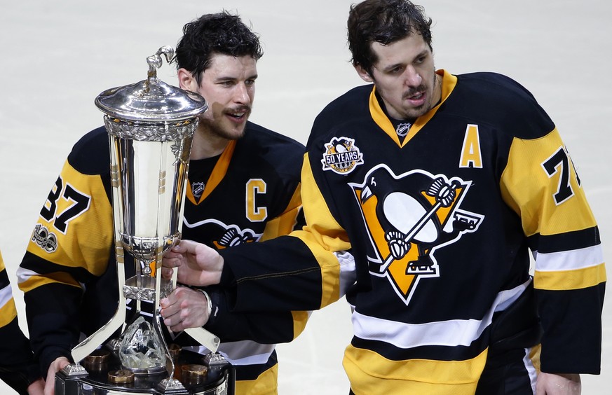 Pittsburgh Penguins&#039; Sidney Crosby (87) and Evgeni Malkin (71) pose with the the Prince of Wales Trophy after beating the Ottawa Senators 3-2 in the second overtime period during Game 7 of the Ea ...