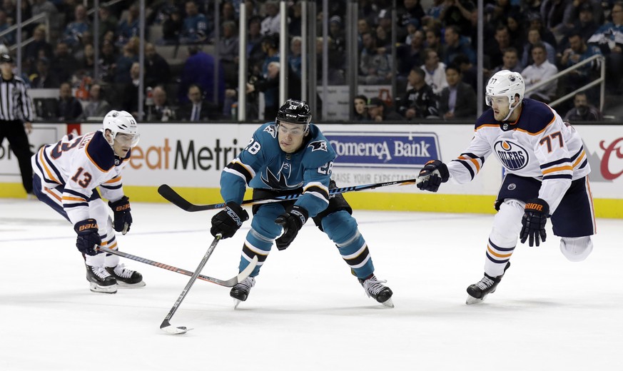 San Jose Sharks&#039; Timo Meier, center, is defended by Edmonton Oilers&#039; Oscar Klefbom, right, and Michael Cammalleri during the second period of an NHL hockey game Tuesday, Feb. 27, 2018, in Sa ...