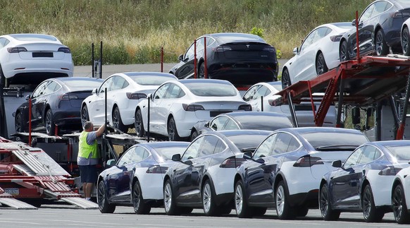 FILE - In this May 13, 2020, file photo, Tesla cars are loaded onto carriers at the Tesla electric car plant in Fremont, Calif. U.S. EPA Administrator Andrew Wheeler on Monday, Sept. 28, 2020, ridicul ...
