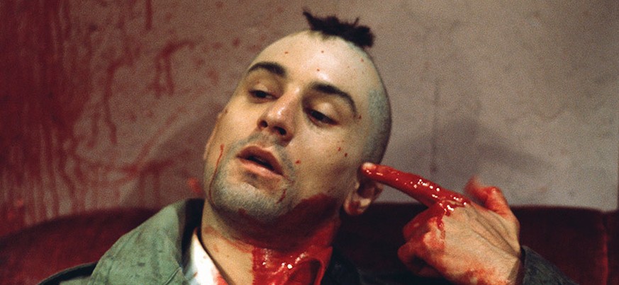 1976 --- Robert De Niro as Travis Bickle points a bloody finger at his head in a suicidal gesture on the set of Martin Scorsese&#039;s Taxi Driver. --- Image by Steve Schapiro http://www.hollywoodrepo ...