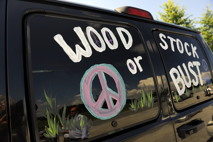 FILE - This Aug. 14, 2009 file photo shows a van decorated with &quot;Woodstock or Bust&quot; at the original Woodstock Festival site in Bethel, N.Y. Woodstock 50 is proving to be as chaotic as the or ...