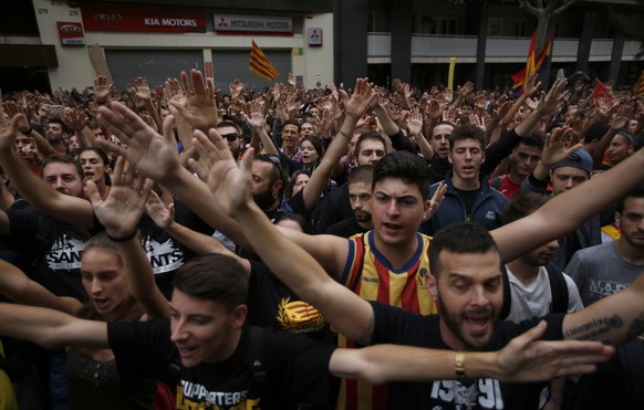 Protestors gather in front of the Spanish Partido Popular ruling party headquarters in Barcelona, Spain, Tuesday Oct. 3, 2017. Labor unions and grassroots pro-independence groups are urging workers to ...