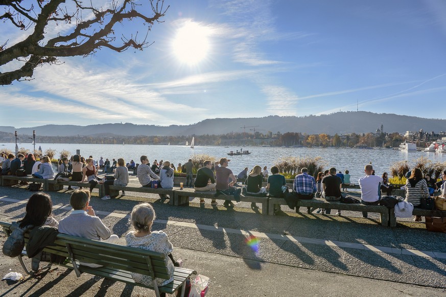 Fast kein Platz bleibt frei bei fruehlingshaften Temperaturen mitten im Herbst am Zuercher Utoquai am Samstag, 7. November 2015. (KEYSTONE/Walter Bieri)....People sitting at lake Zurich take advantage ...