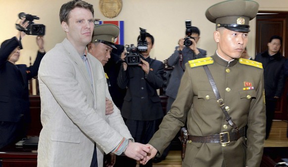 epa06038136 (FILE) - A file handout photo provided by the official Korean Central News Agency (KCNA)shows Otto Frederick Warmbier (L) in relation to his trial held by The Supreme Court of the Democrat ...