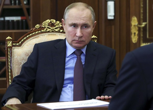 Russian President Vladimir Putin listens during a meeting in Moscow, Russia, Thursday, Feb. 4, 2021. (Mikhail Klimentyev, Sputnik, Kremlin Pool Photo via AP)