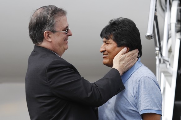 Mexican Foreign Minister Marcelo Ebrard, left, welcomes former Bolivian President Evo Morales upon his arrival to Mexico City, Tuesday, Nov. 12, 2019. Mexico granted asylum to Morales, who resigned on ...