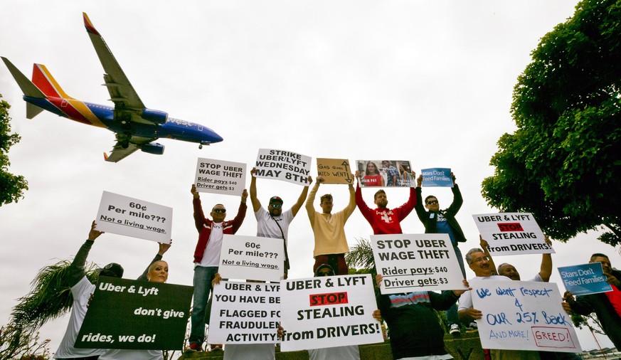 Drivers for ride-hailing giants Uber and Lyft hold a rally at a park near Los Angeles International Airport, Wednesday, May, 8, 2019, in Los Angeles. Some drivers for ride-hailing giants Uber and Lyft ...