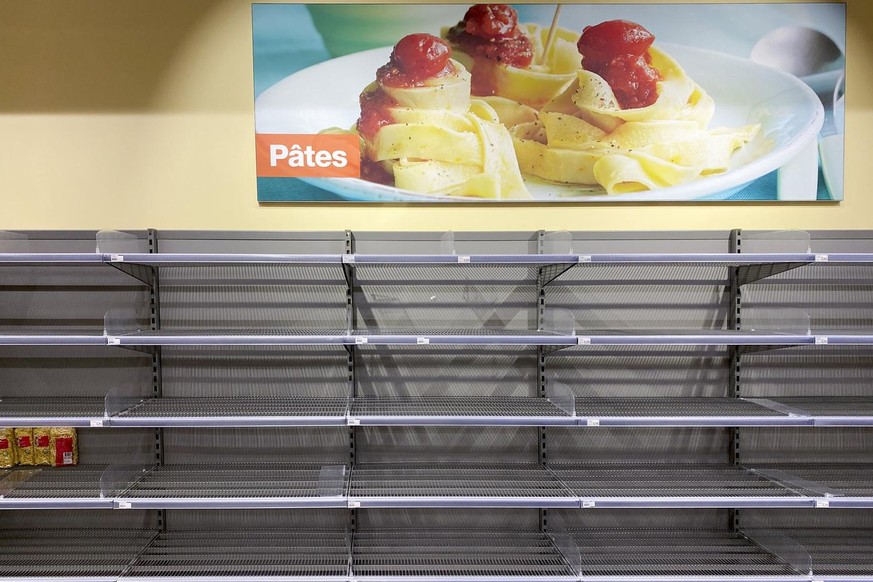 Empty pasta shelves are pictured in a supermarket during the Covid-19 Coronavirus pandemic in Crissier, Switzerland, Friday, March 13, 2020. (KEYSTONE/Jean-Christophe Bott)