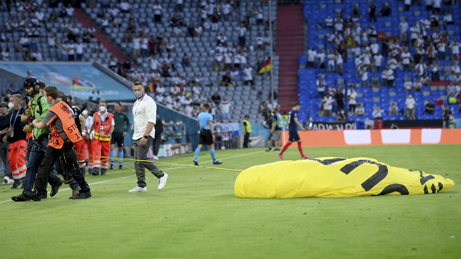 A protestor is lead of the pitch before the Euro 2020 soccer championship group F match between France and Germany at the Allianz Arena stadium in Munich, Tuesday, June 15, 2021. (Matthias Hangst/Pool ...