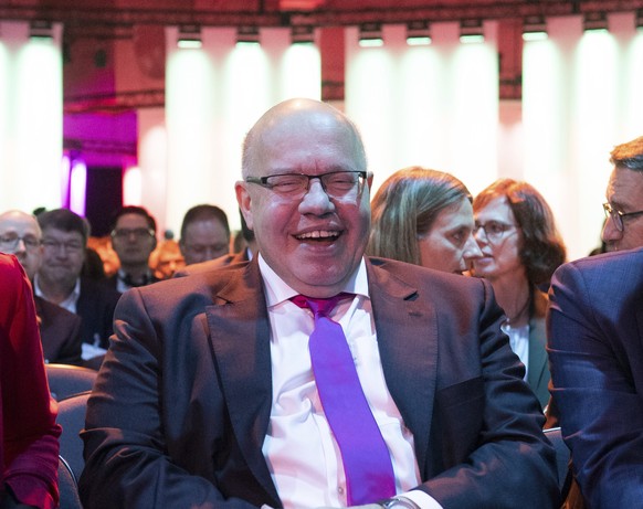 German Economy Minister Peter Altmaier, center, sits between Science and Education Minister Anja Karliczek, left, and Achim Berg, President of the Bitkom e.V during the opening ceremony of a Digital S ...