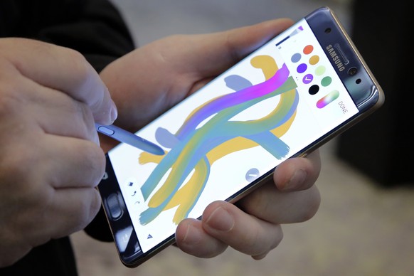 FILE - In this July 28, 2016, file photo, a color blending feature of the Galaxy Note 7 is demonstrated in New York. An overheated Samsung device created smoke that caused a plane to be evacuated at L ...