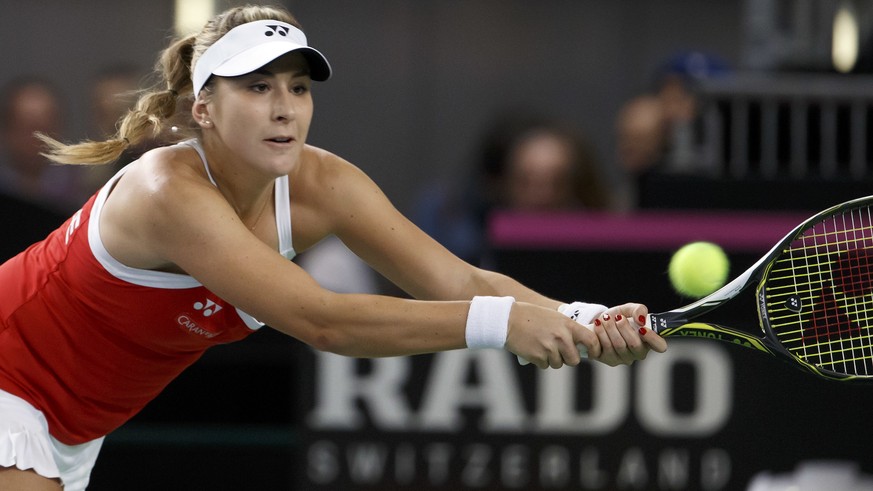 Belinda Bencic of Switzerland returns a ball to Pauline Parmentier of France, during the fourth single tennis match, of the Fed Cup World Group first round match between Switzerland and France, at Pal ...