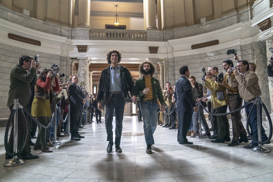 This image released by Netflix shows Sacha Baron Cohen, center left, and Jeremy Strong in a scene from &quot;The Trial of the Chicago 7.&quot; (Niko Tavernise/Netflix via AP)