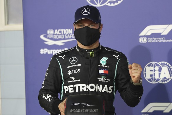 Mercedes driver Valtteri Bottas of Finland, who earned pole position, celebrates after the qualifying for the Bahrain Formula One Grand Prix, at the Formula One Bahrain International Circuit in Sakhir ...