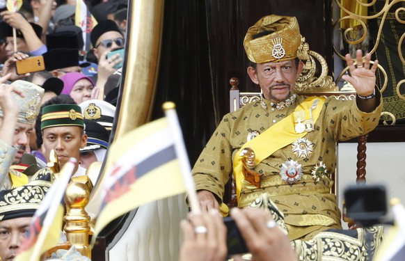 epa07475105 (FILE) Brunei&#039;s Sultan Hassanal Bolkiah waves to well-wishers during a procession as part of the Golden Jubilee celebrations in Bandar Seri Begawan, Brunei, 05 October 2017 (reissued  ...