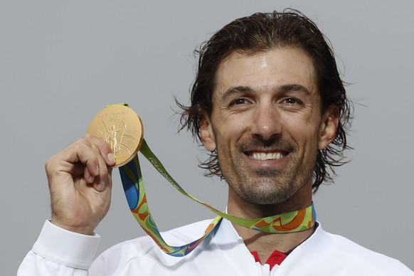 Cyclist Fabian Cancellara of Switzerland holds his gold medal during the podium ceremony of the men&#039;s individual time trial event at the 2016 Summer Olympics in Pontal beach, Rio de Janeiro, Braz ...